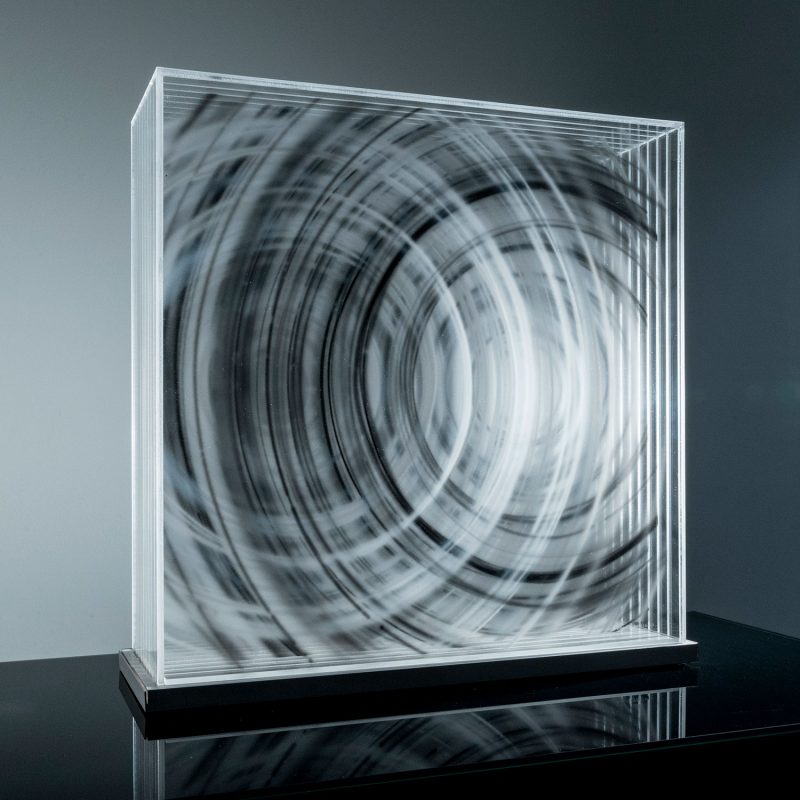 David Spriggs artwork of white and black concentric circles expanding outwards overlapping one another